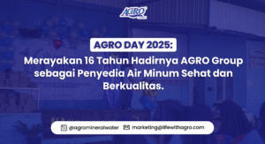 Banner AGRO DAY 2025 dengan teks 'Merayakan 16 Tahun Hadirnya AGRO Group sebagai Penyedia Air Minum Sehat dan Berkualitas' di depan panggung acara perayaan dengan dekorasi balon dan latar biru.